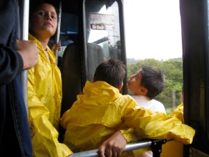 School boys, decked out in their rain gear and ready to swim home